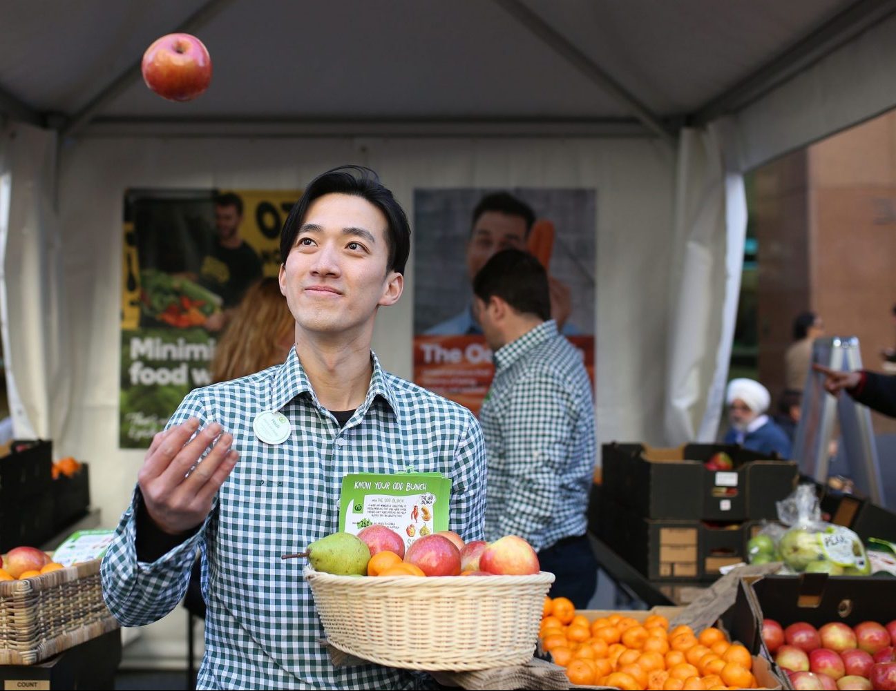 Woolworths-staff-throwing-apple-1-scaled-e1606425477812