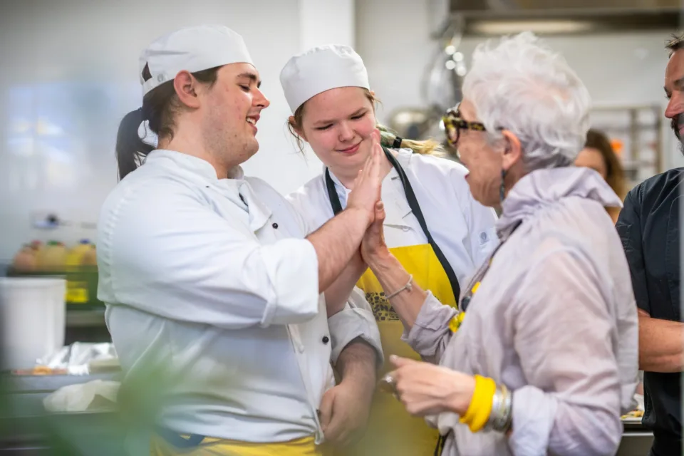 Ronni high fiving a Nourish student