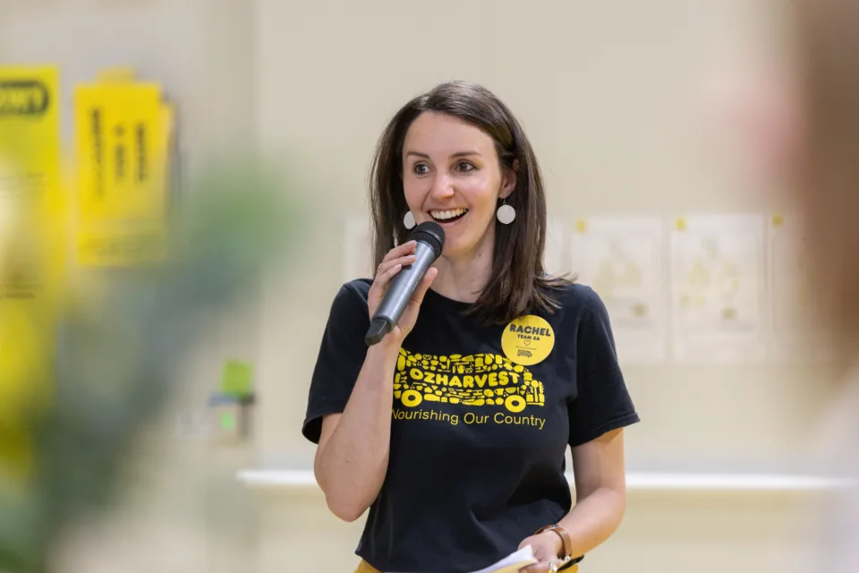 OzHarvest Adelaide State Manager Rachel Hibble speaking into a microphone.